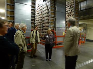 Donna Peterson addresses Tim Johnson, with a group in the depths of the Library Archives, Sept 27